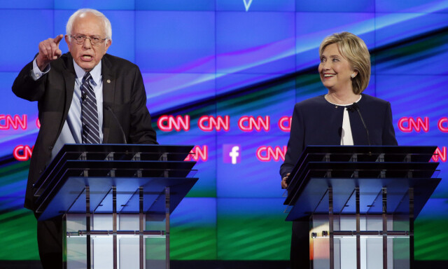 FILE - In this Tuesday, Oct. 13, 2015, file photo, Sen. Bernie Sanders, of Vermont, left, speaks as Hillary Clinton watches during a CNN Democratic presidential debate in Las Vegas.Every presidential race has its big moments. This one, more than most. (AP Photo/John Locher, File)